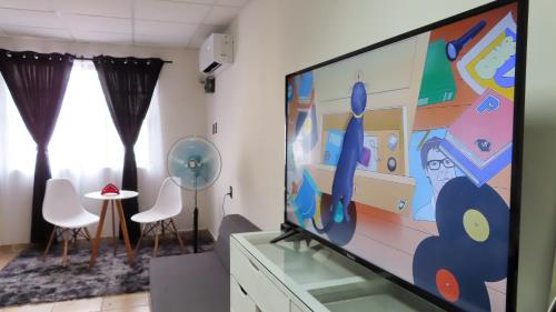 a living room with a large flat screen tv at Comfortable and Centrally Located Accommodation in Altamira