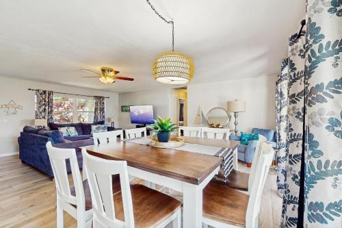 a dining room and living room with a table and chairs at Relax in Retro in Clearwater