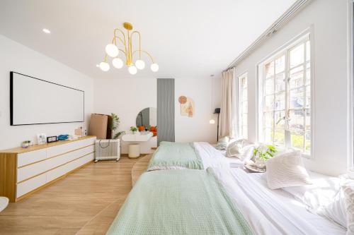 a white bedroom with a large bed and a tv at 柃居 B&B - Jing'an Temple Branch in Shanghai
