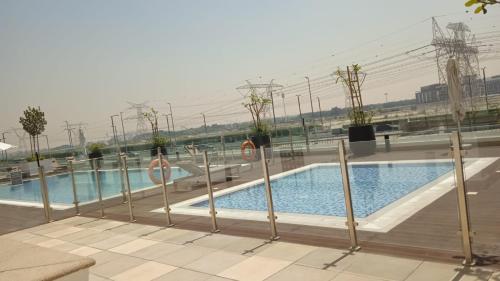 a swimming pool on the roof of a building at Smart & Modern Living in Heaven! in Dubai