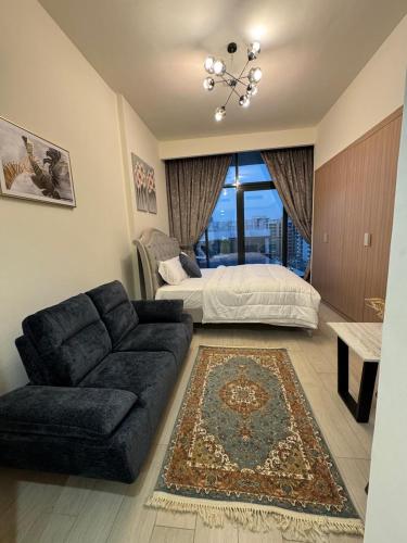 a living room with a couch and a bed at Smart & Modern Living in Heaven! in Dubai