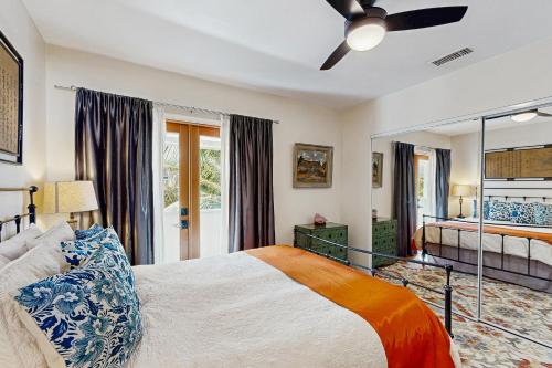 a bedroom with a bed and a ceiling fan at Cedar Oasis in Ventura