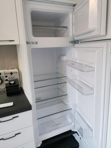 a white refrigerator with its door open with its shelves at Mare e Trabocchi in Fossacesia