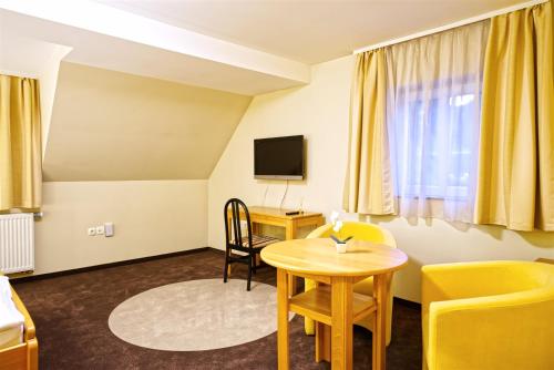 a hotel room with a table and a desk at Vila Sofia in Tržič