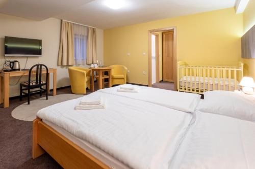 a hotel room with two beds and a table and chairs at Vila Sofia in Tržič