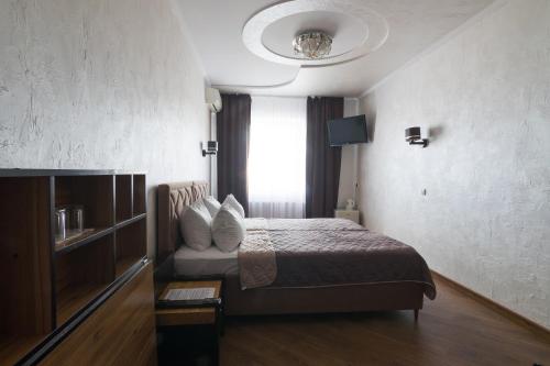 a hotel room with a bed and a window at Шахерезада in Vinnytsya
