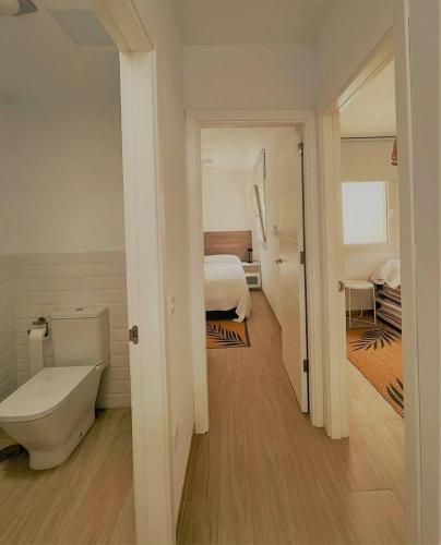 a bathroom with a bed and a toilet in a room at Sunset Bastián, junto a la costa in Costa Teguise