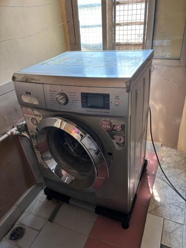 a washing machine with a blue counter on top of it at Luxurious Duplex-Himayath nagar in Lālāguda