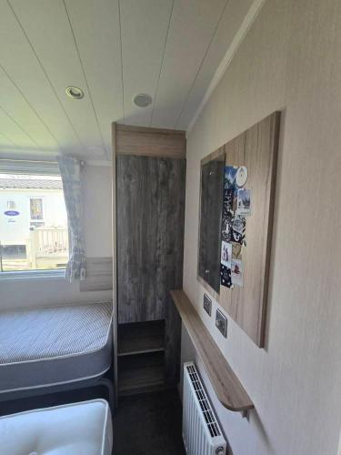 a small room with a bed and a window at Haven Burnham on sea 16 Elm Grove in Burnham on Sea