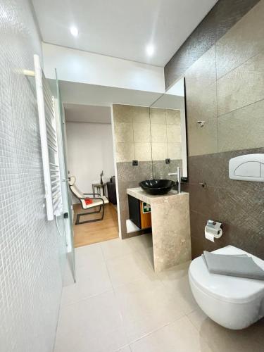 a bathroom with a toilet and a sink at Casa da Praceta in Lisbon