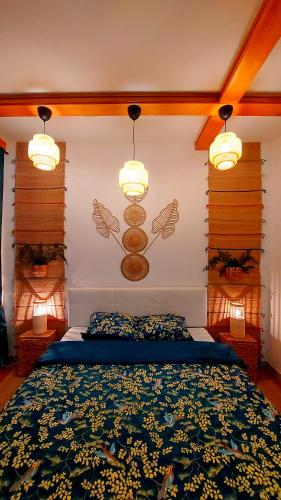 a bedroom with a bed with blue sheets and lights at 2 room's Family Apartments Zemlinski 12 in Payerbach
