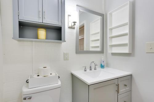 a white bathroom with a sink and a mirror at Near Parks and Lakes Pet-Friendly Winnie Cottage in Winnie