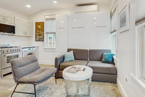 a living room with a couch and a table at Provincetown Paradise in Provincetown