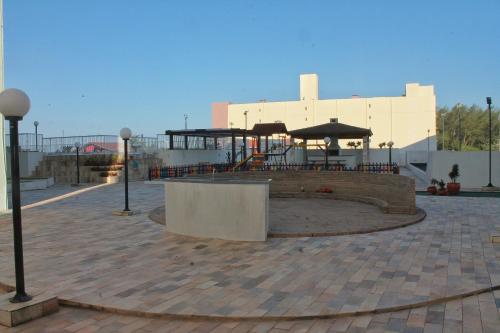 a pavilion with tables and umbrellas on a patio at Resid. Clube Mar Grosso - Laguna - LAG201 in Laguna