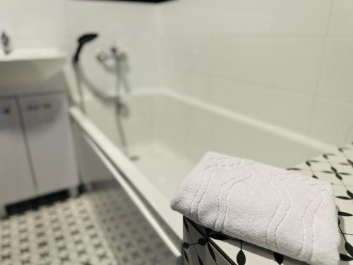 a bathroom with a towel sitting on a stool at Rodzinna Przystań in Wałbrzych