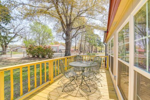 a patio with a table and chairs on a balcony at Walk to Beach Eufaula Fishermans Delight Home in Eufaula