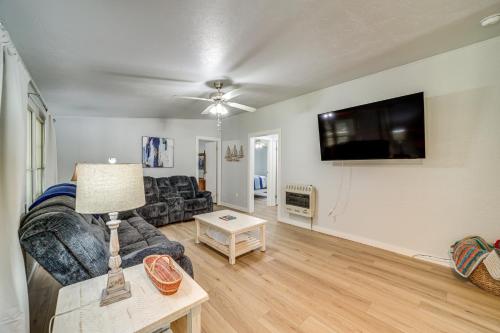 a living room with a couch and a flat screen tv at Walk to Beach Eufaula Fishermans Delight Home in Eufaula