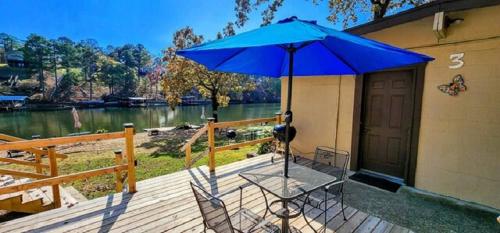 a blue umbrella sitting on top of a wooden deck at #03 - Fantastic Lakeside Studio Cottage- Pet Friendly in Hot Springs