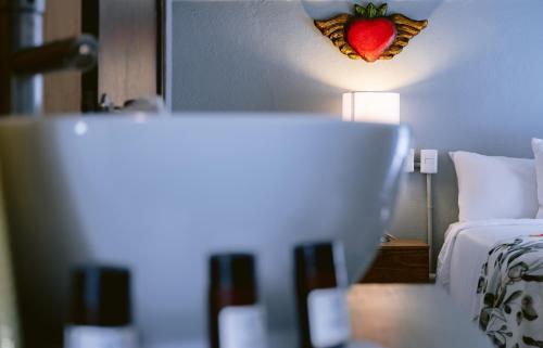 a room with a bed with a strawberry on the wall at Casa Xaca in San Miguel de Allende