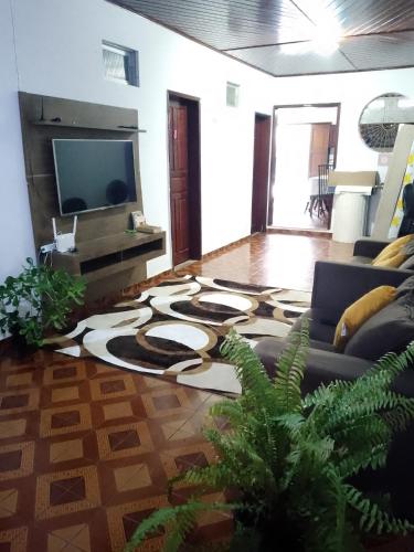 a living room with a couch and a flat screen tv at Elizondopousada03 in Belém