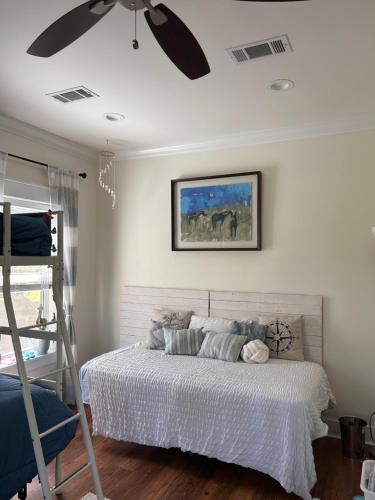 a bedroom with a bed and a ceiling fan at 3 Bed, 2 and a half bath Gorgeous Coastal Home 1 block from beach! in Long Beach