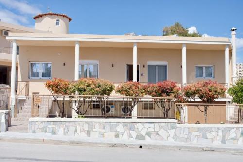 a house with flowers in front of it at Skyway Comfort Residences in Spáta