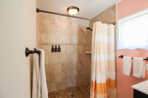 a shower with a shower curtain in a bathroom at Beautiful 3 BR pool home minutes from Siesta Key - Blue Dolphin in Sarasota