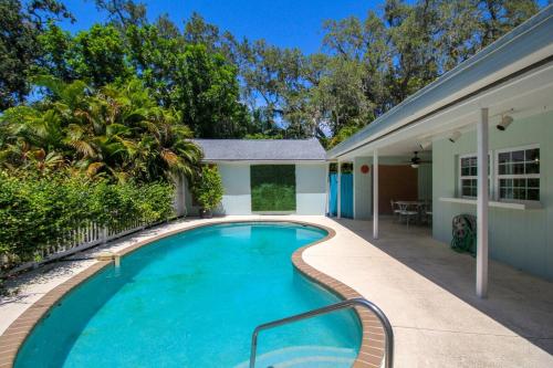 a swimming pool in front of a house at Beautiful 3 BR pool home minutes from Siesta Key - Blue Dolphin in Sarasota