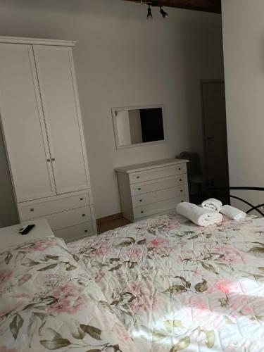 a bedroom with a bed and a dresser and a tv at Bed breakfast L'AMICO in Alghero