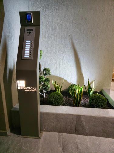 an atm machine in a room with plants at 8 Blocks Apartments in Alexandroupoli