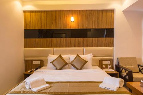 Ένα ή περισσότερα κρεβάτια σε δωμάτιο στο Grand Plaza Suites