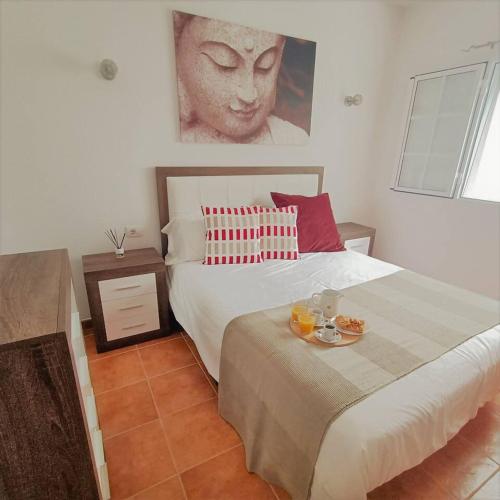 a bedroom with a bed with a plate of food on it at Mara´s House, oasis de paz in Nazaret