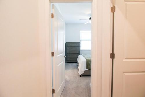 a room with a bedroom with a bed and a door at Serene lakefront pool home in Lorraine Lakes - Coral Paradise in Bradenton