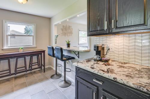 a kitchen with a counter and a bar in it at Greensboro Vacation Rental 2 Mi to Downtown! in Greensboro