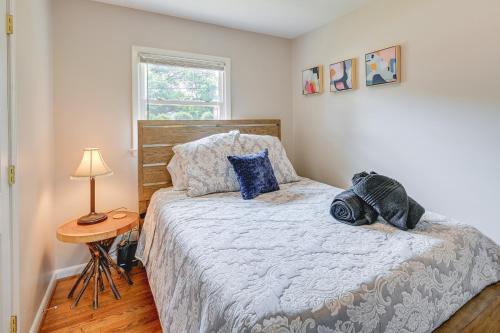 a bedroom with a bed with blue pillows on it at Greensboro Vacation Rental 2 Mi to Downtown! in Greensboro