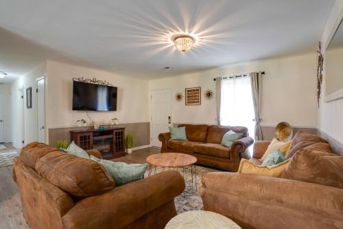a living room with leather couches and a tv at Decatur Vacation Rental Retreat with Private Yard! in Decatur