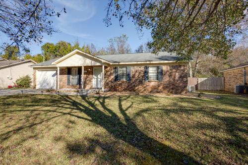 a house with a tree in the yard at Decatur Vacation Rental Retreat with Private Yard! in Decatur