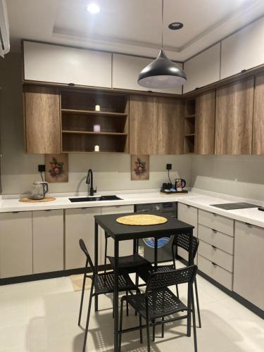 a kitchen with a table and chairs in it at mariella 1 in Jeddah