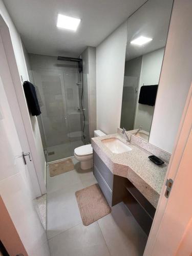 a bathroom with a toilet and a sink and a shower at Loft SUNSET - 8 ANDAR in Dourados