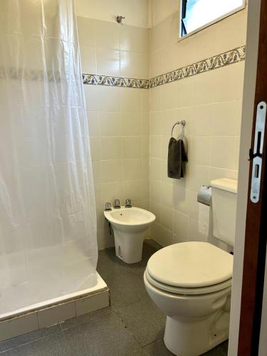 a bathroom with a toilet and a sink at Las Luciérnagas del Delta 2 in Tigre