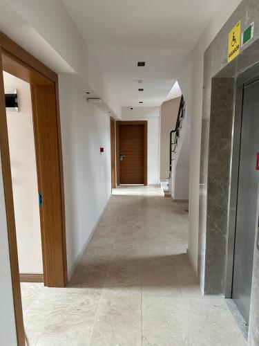an empty hallway with a staircase in a building at Grape Hotel in Ezine