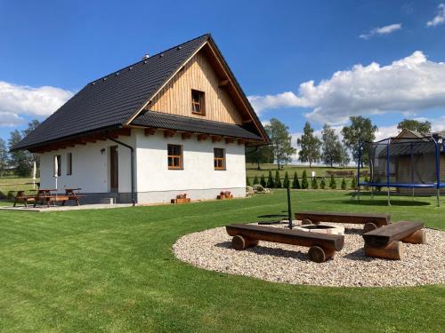 a building with a picnic table and a playground at Chalupa pod Volákovým kopcem in Kameničky