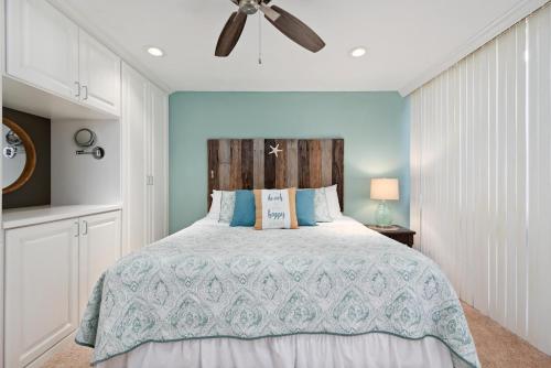 a bedroom with a bed and a ceiling fan at Gorgeous Lido Key condo - 6 minute walk to beach in Sarasota