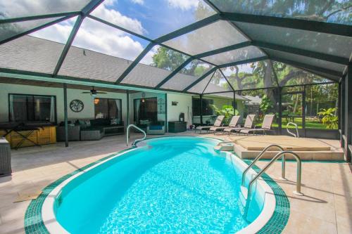 a swimming pool under a tent with a swimming pool at Elegant 3BR 2BA Private Pool Home in Palmetto