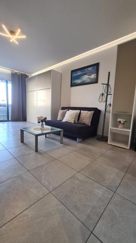 a living room with a couch and a table at SEA SIDE studio in Oostduinkerke