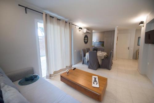 a living room with a couch and a table at Regalo Apartments in Lygia