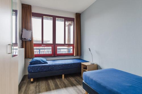 Postel nebo postele na pokoji v ubytování Appartement at lake Veluwemeer, nearby Harderwijk, 63km from Amsterdam