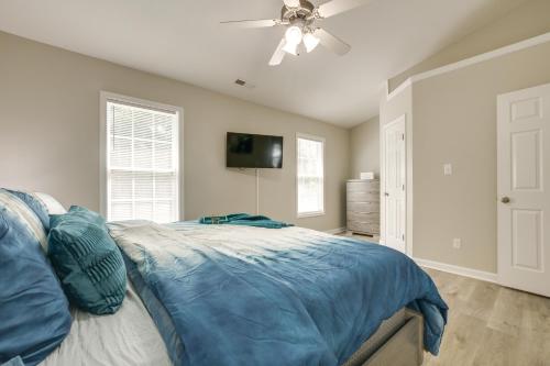a bedroom with a bed and a ceiling fan at Pets Welcome Townhome with Patio in Raleigh! in Raleigh
