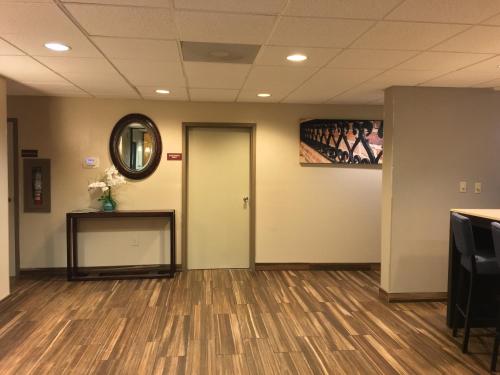 a waiting room with a door and a mirror at Baymont by Wyndham Rocky Mount I-95 in Rocky Mount
