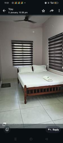 a bedroom with a large bed in a room at JOSEPH'S HOMESTAY in Fort Kochi